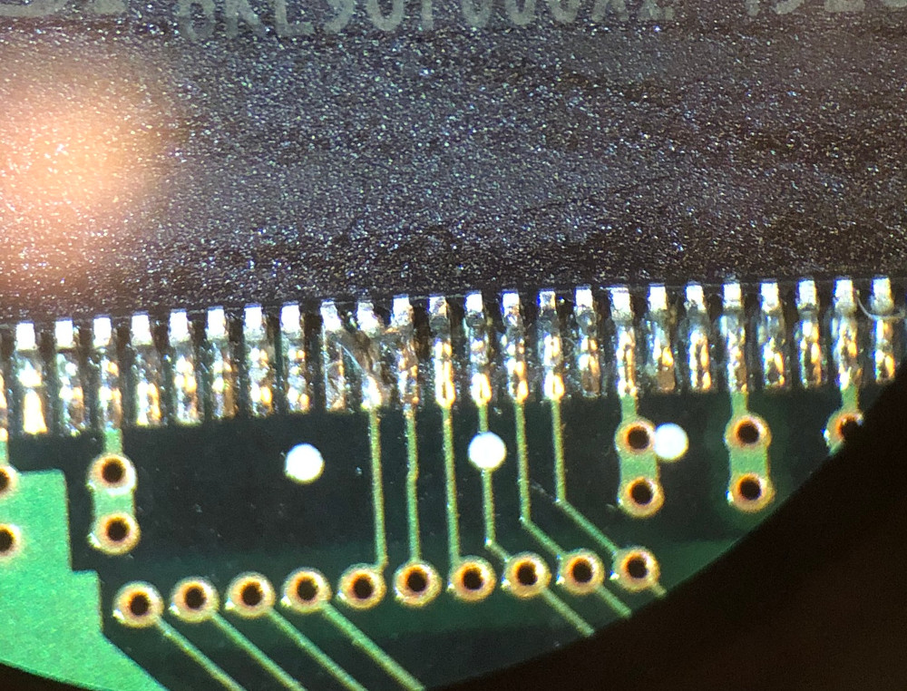 A closeup photo of the IC102 SDRAM showing pins 22 and 23 soldered to the
pads to their right