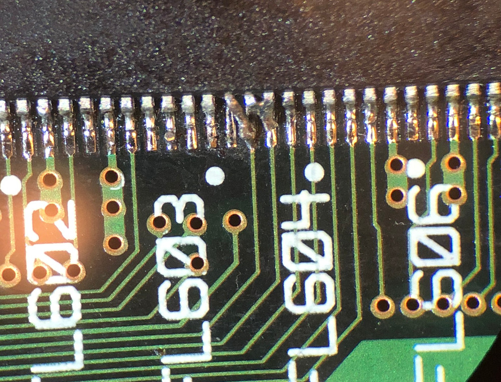 A closeup photo of the IC103 SDRAM showing pins 22 and 23 soldered to the
pads to their right
