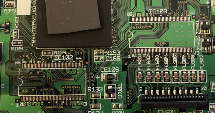 Photo of Dreamcast motherboard showing bare pads where IC102 and IC103 have
been removed