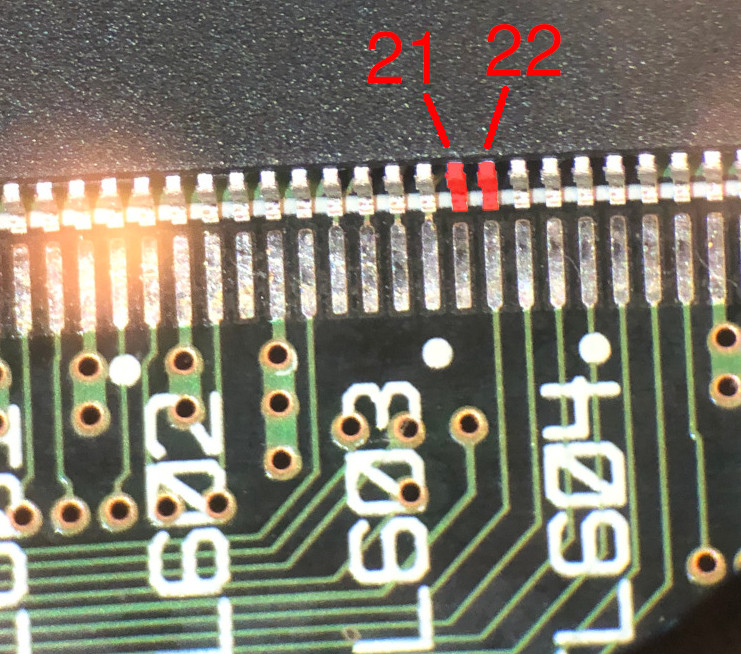 Photo through microscope of an SDRAM chip with pins 21 and 22 highlighted and
labeled in red