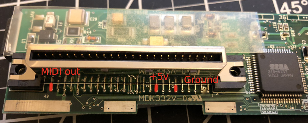 The G2 connector of a Dreamcast modem PCB with pins 11 (ground), 17 (+5V), and 49 (MIDI OUT) identified